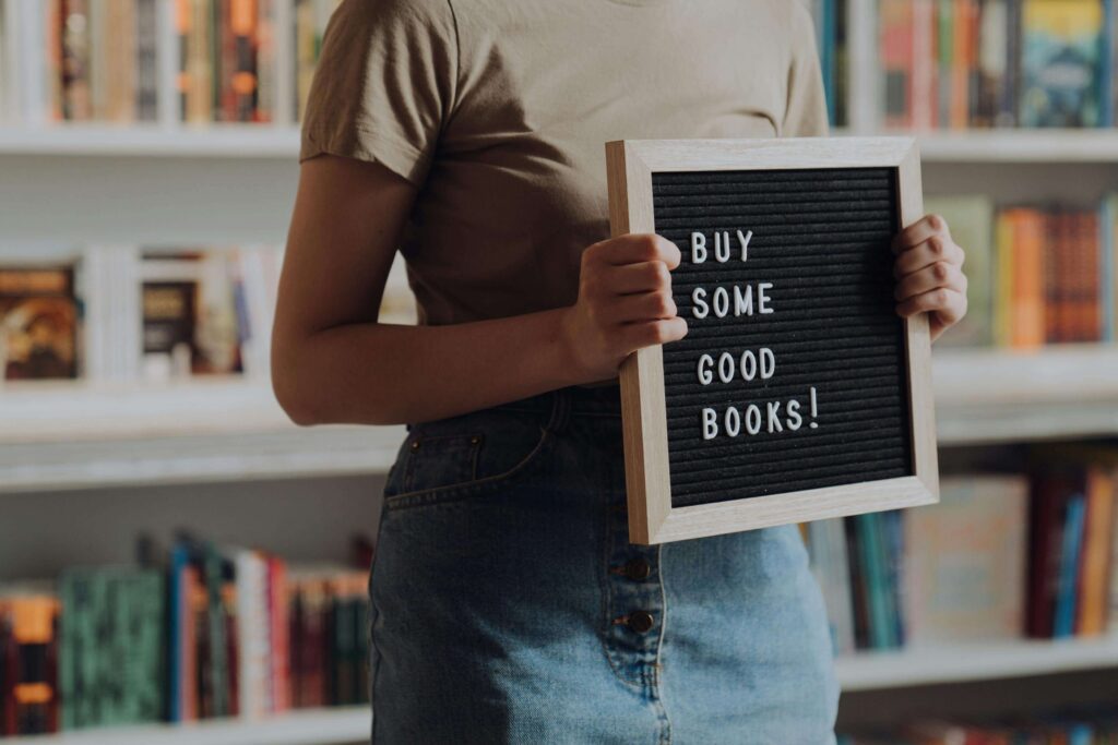 Author selling books in a bookstore