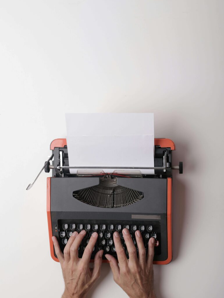 author writing through a typewriter