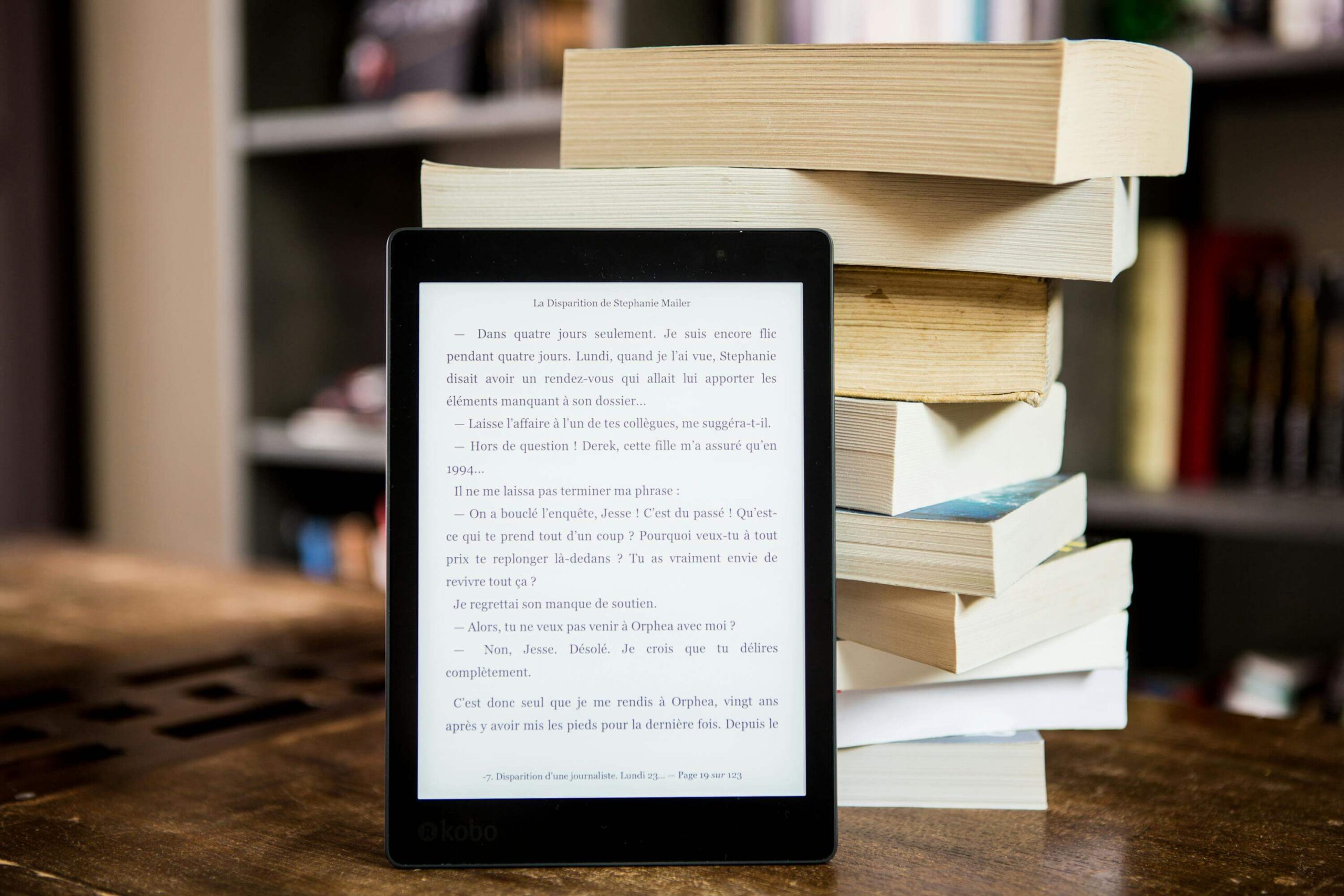 ebook shown on a tablet leaning against a stack of books