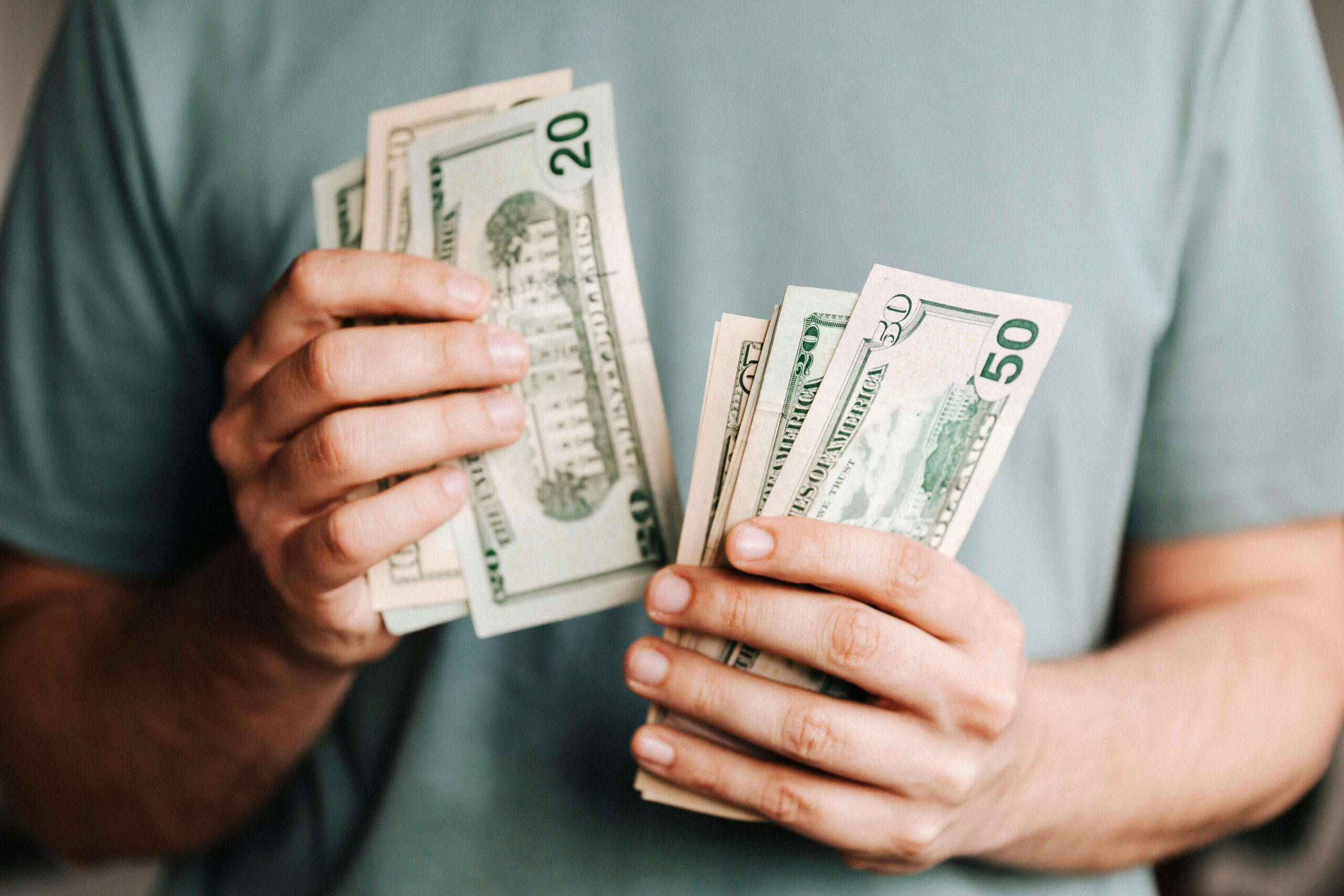 author holding the money they earned from audiobooks