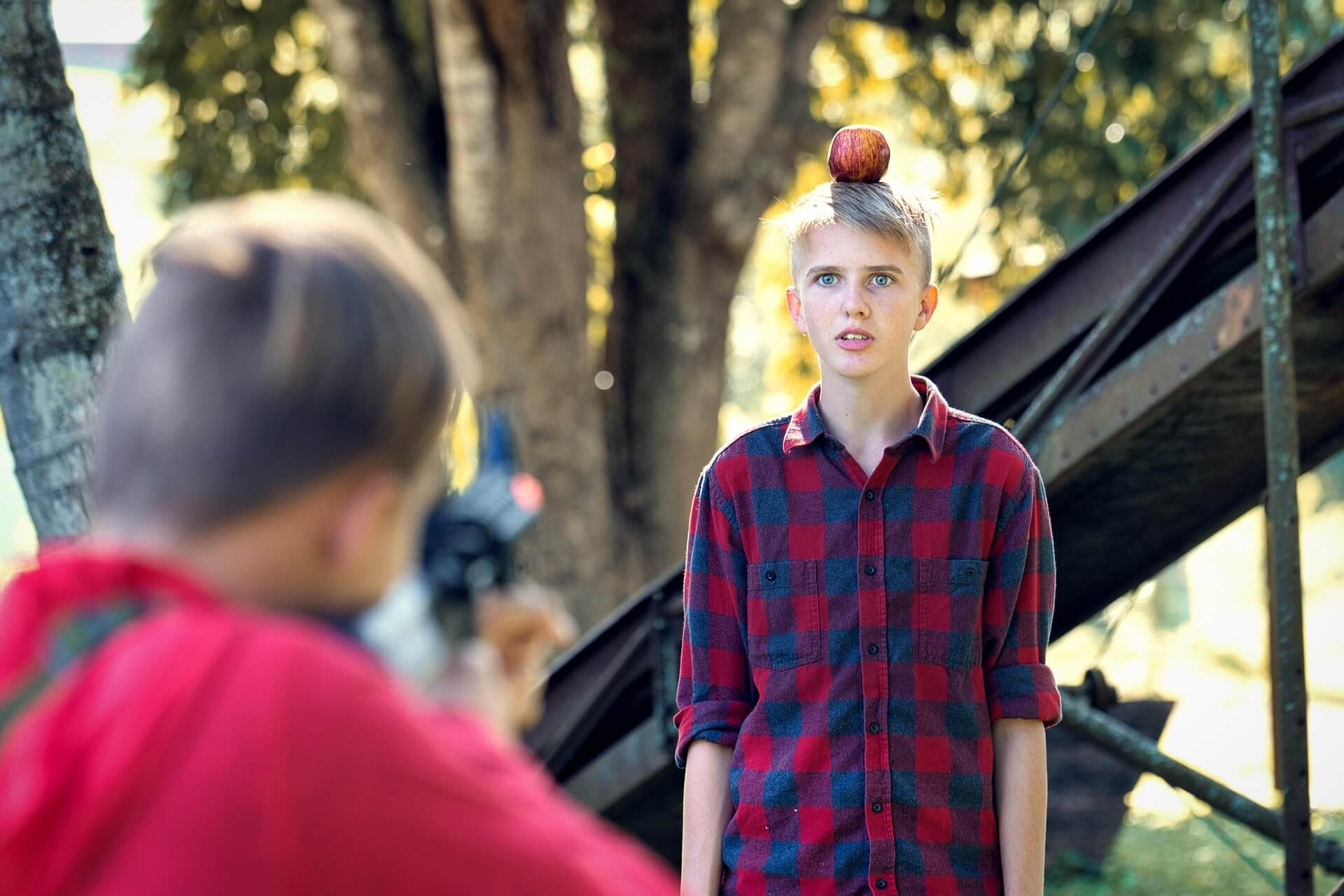 boy with an apple on his head risking his life