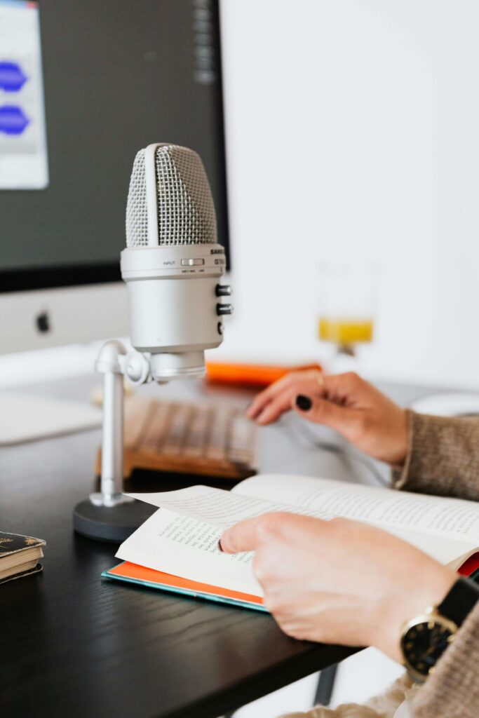 author reading his books through a speaker