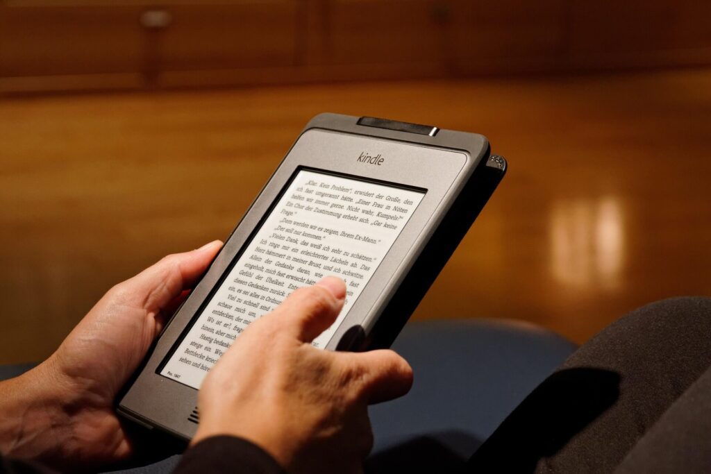 Book lover reading an ebook from Amazon Kindle