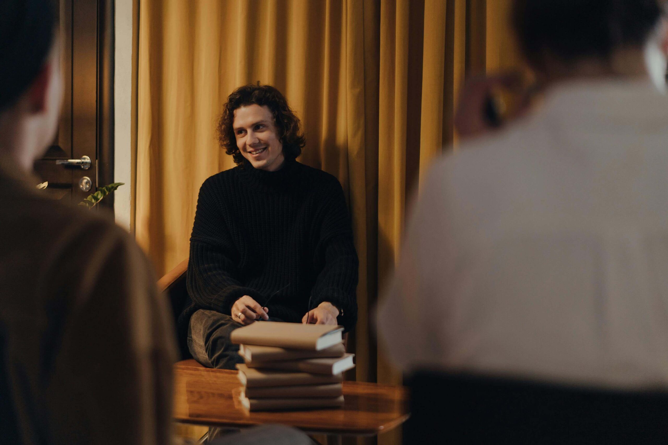 author launching his book and signing copies for an audience