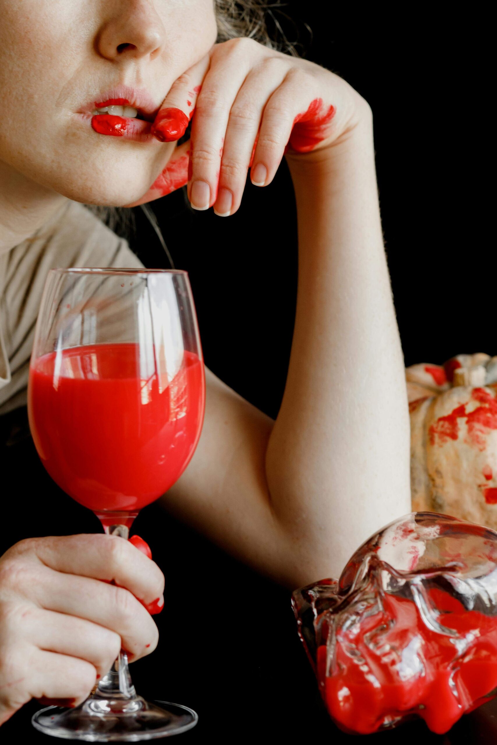 woman with fake blood in a wine glass