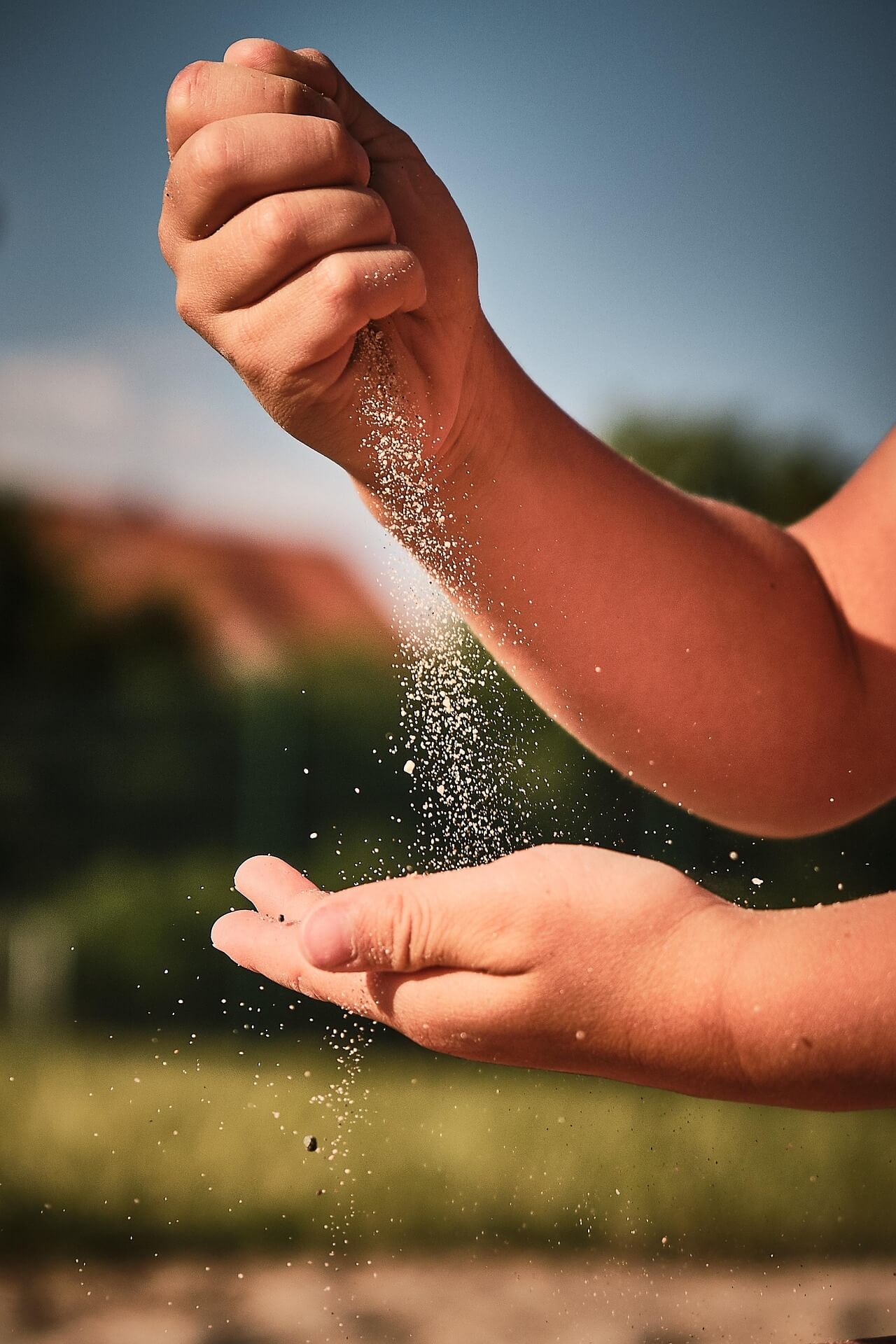 sand dust trickling from hand to hand