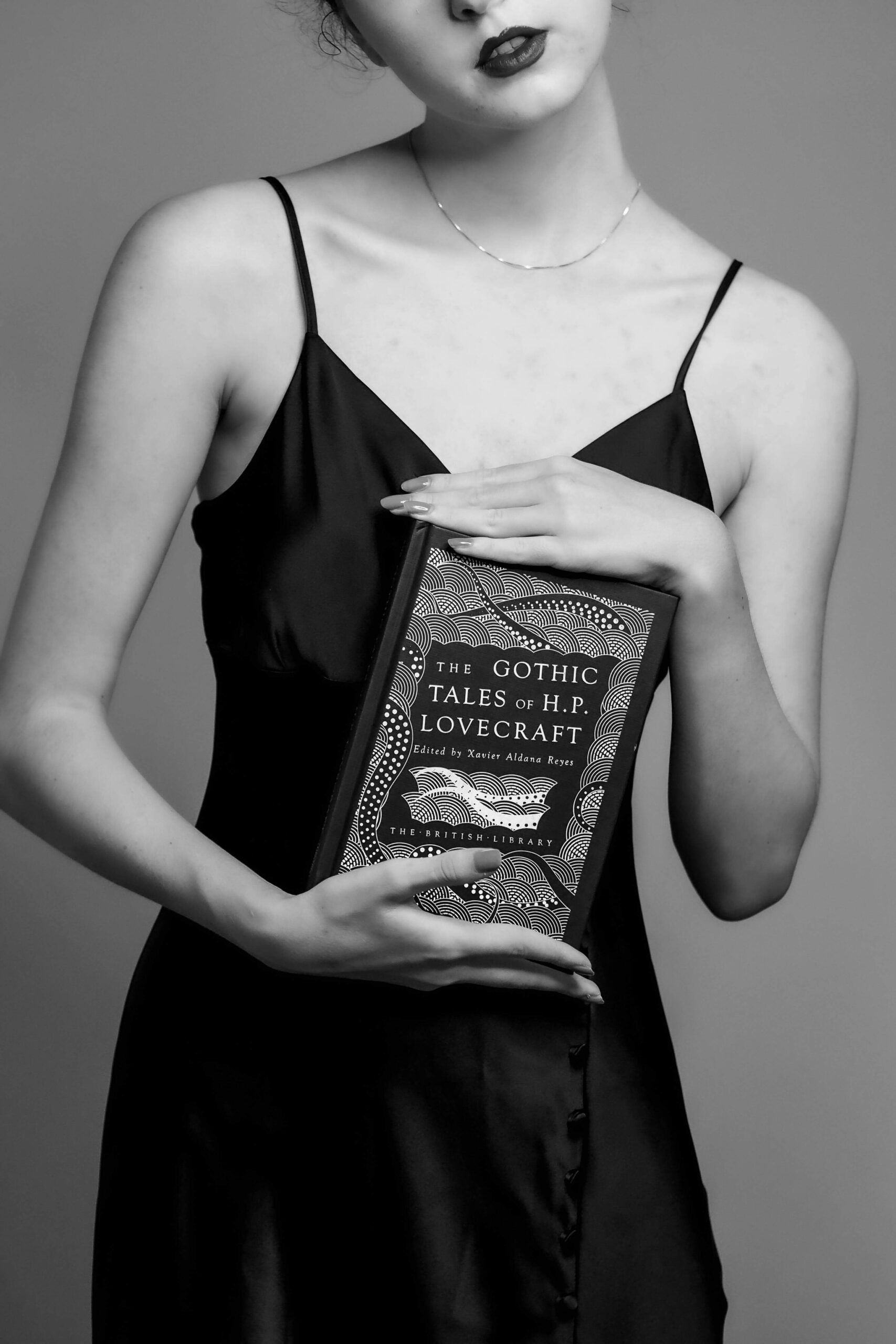 woman holding a mystery novel cover
