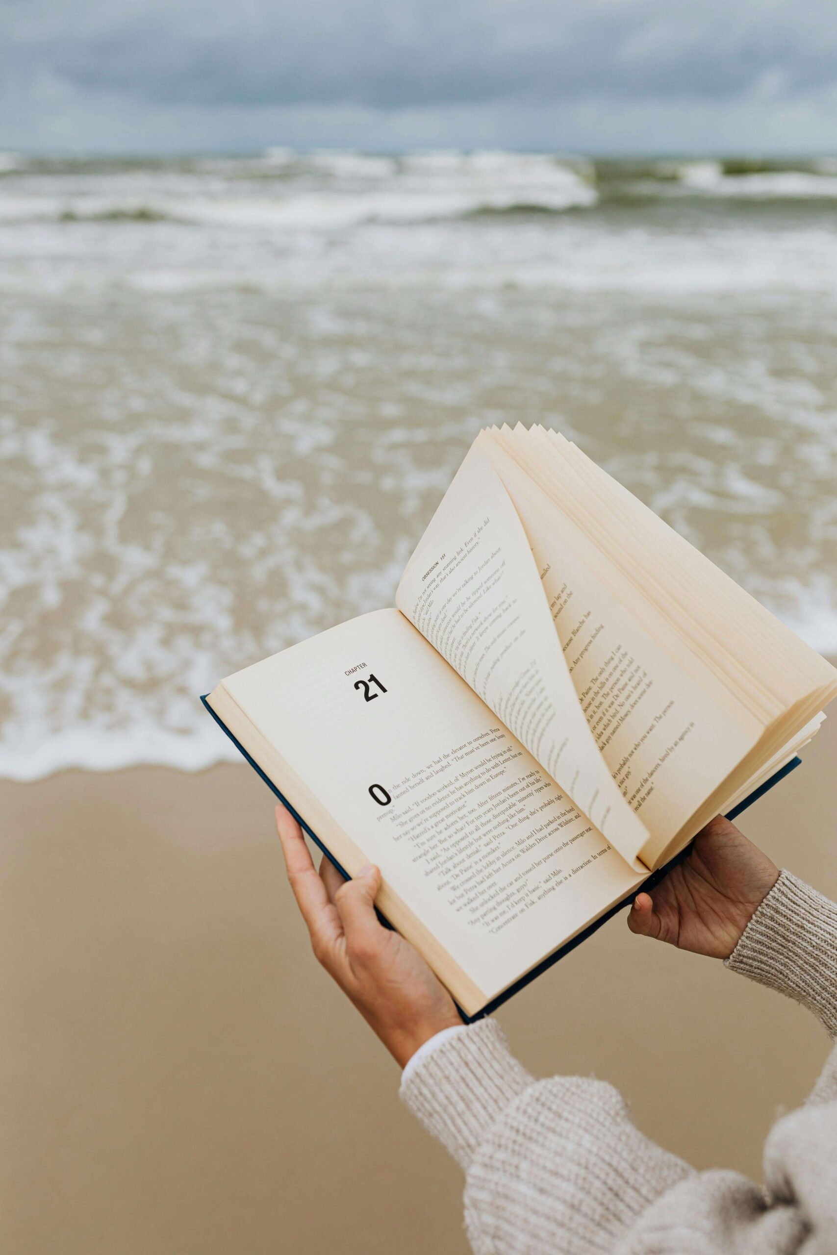 reading a book by the sea