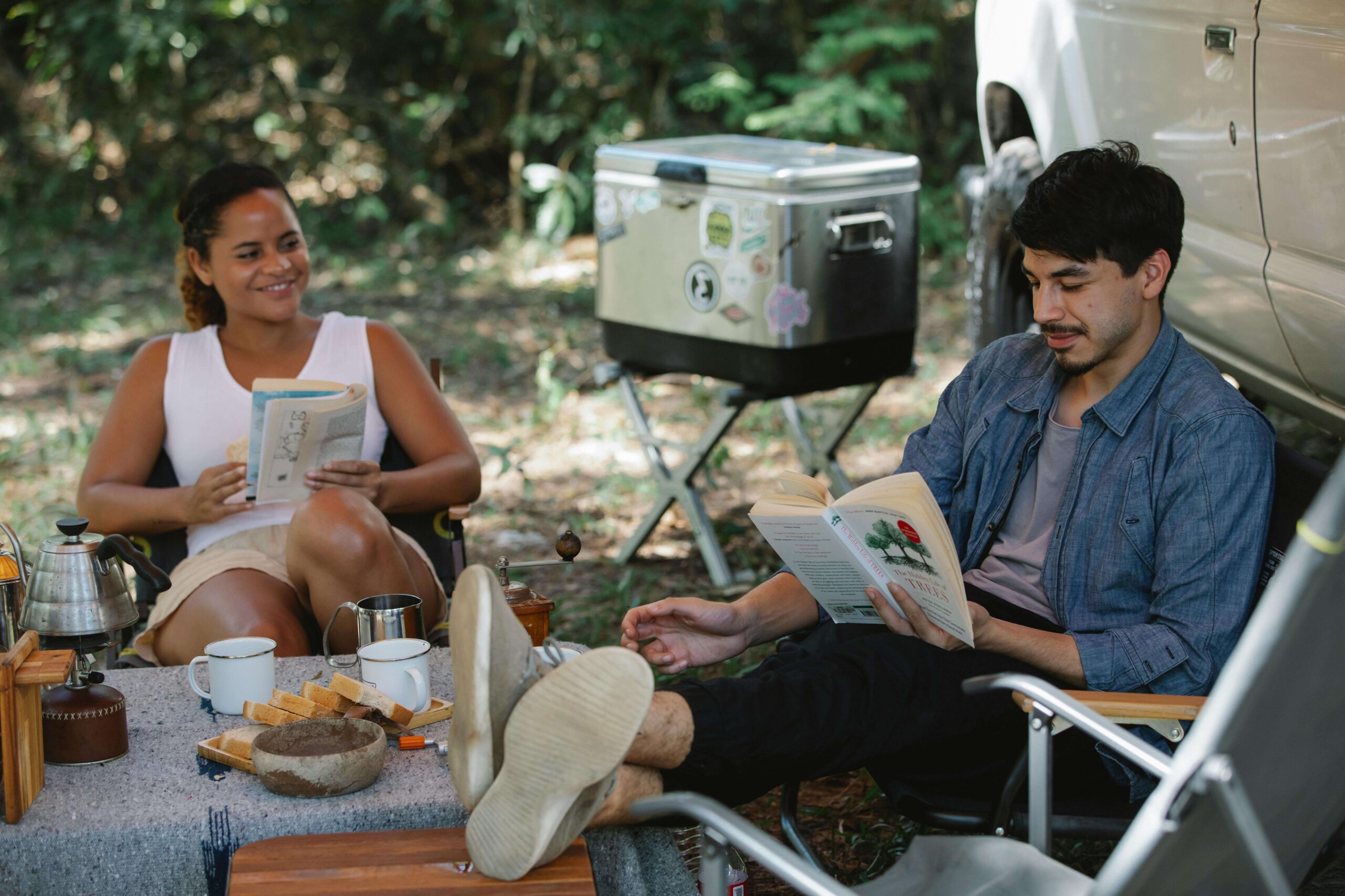man and woman reading books while traveling