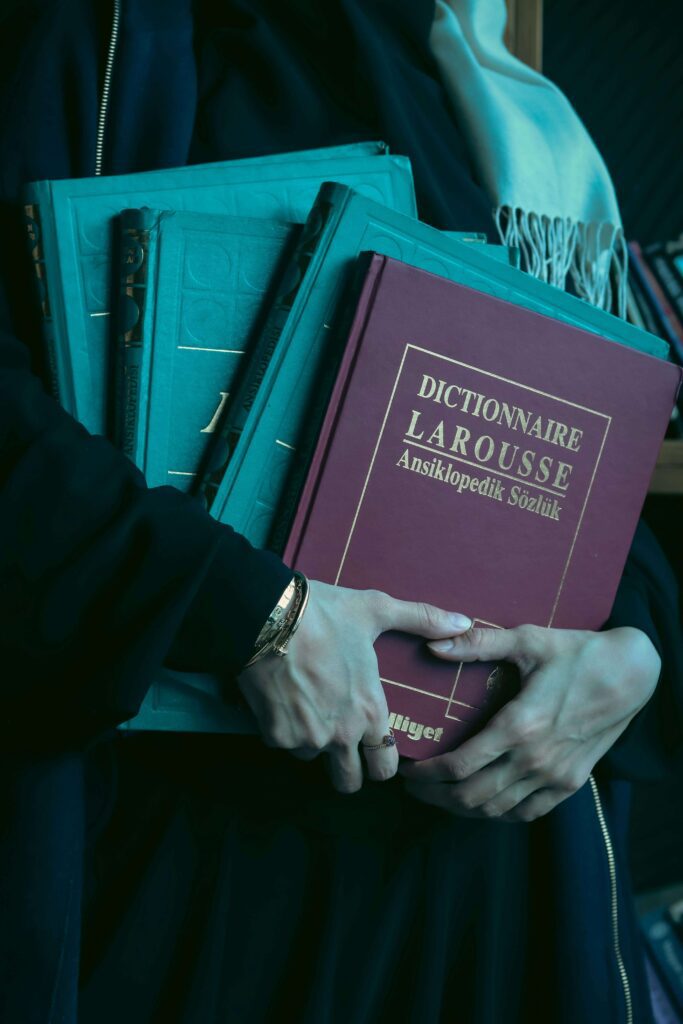Man holding dictionaries